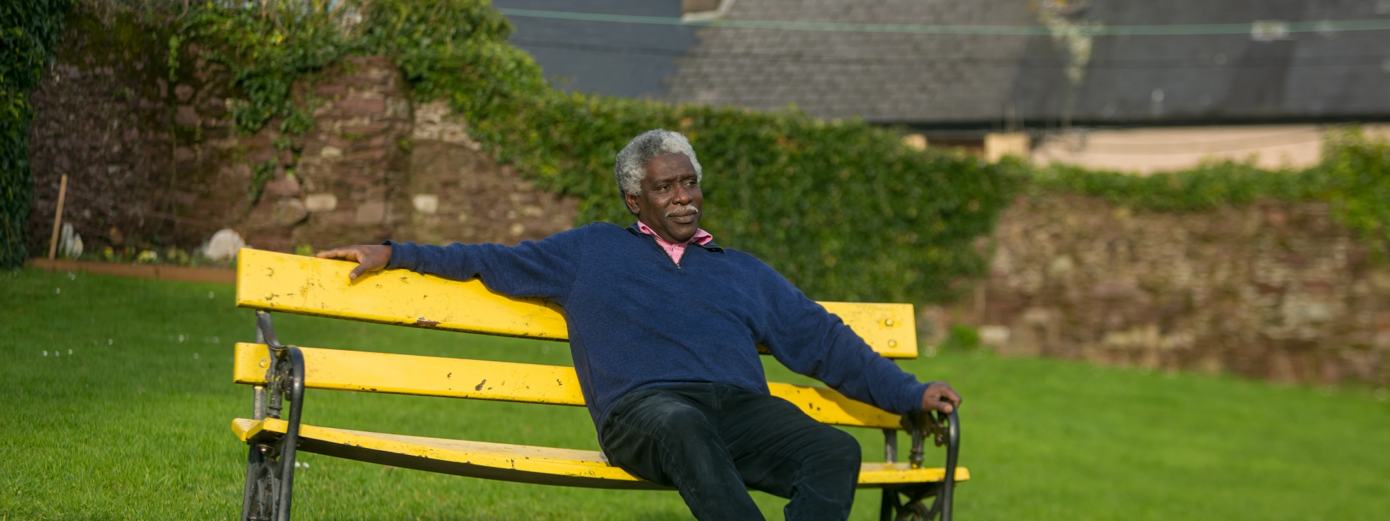 Man sitting on public bench in a park