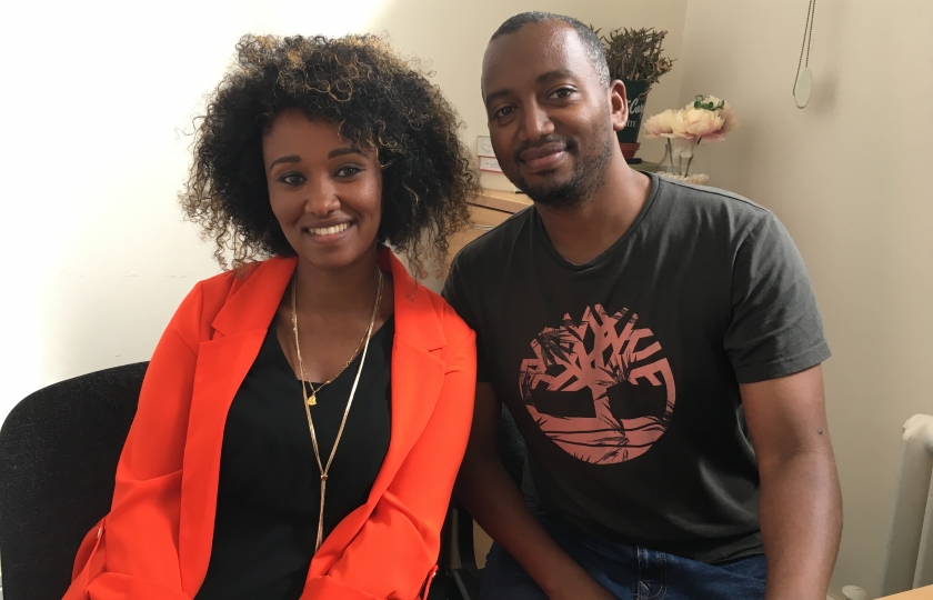 Romadi and Abel sitting in an office