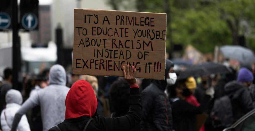 people holding brown wooden signage during daytime
